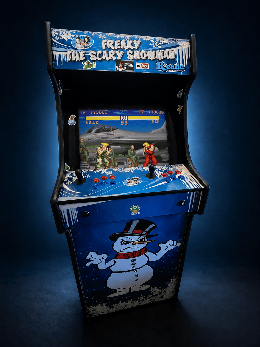 Front view of the custom blue Freaky the Scary Snowman arcade cabinet showing a classic fighting game on its screen